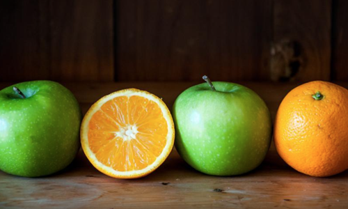 Apple-and-orange-fruit-on-brown-wooden-background-from-Freerange.png